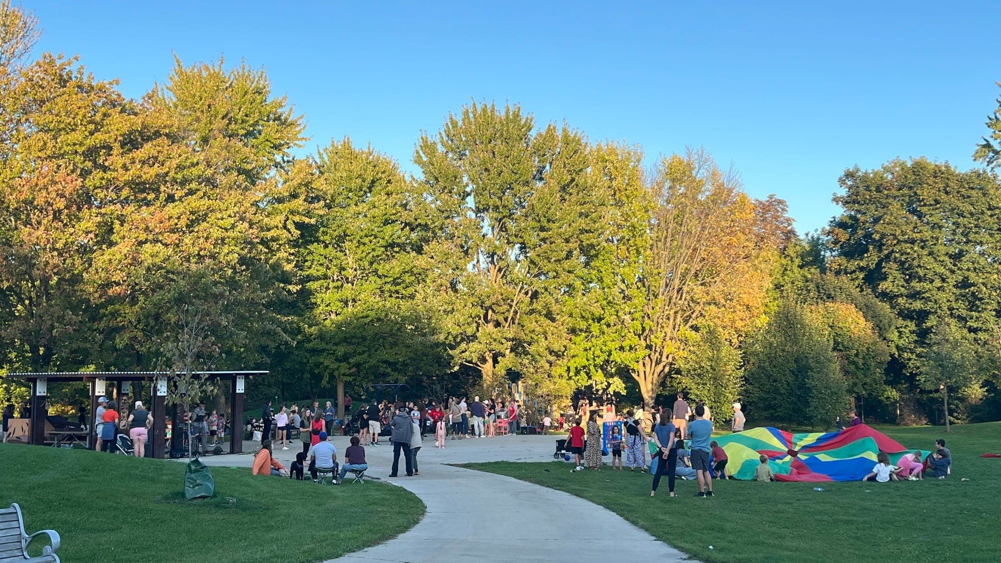 Neighbours gathered in the park at golden hour